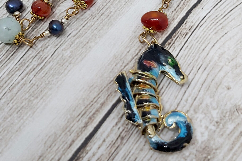 beaded necklace with a seahorse pendant